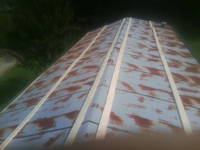 Rusted metal roof panels with new wood purlins before replacement — Storm Damage Roof Repair in Shingle Springs by Roofing Brothers